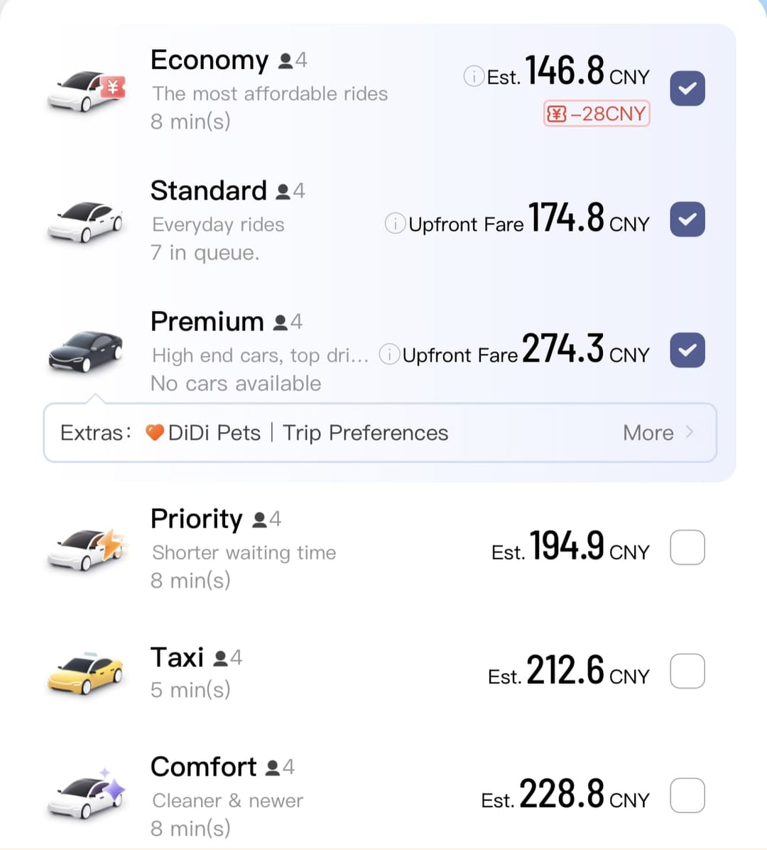 Pantalla de la app de DiDi en inglés con Economy, Standard, Premium, Priority, Taxi y Comfort, cada uno con su precio